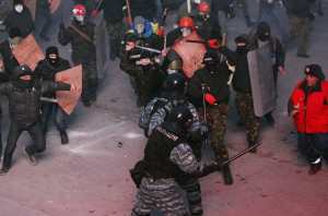 Pro-European integration protesters clash with Ukranian riot police during a rally near government administration buildings in Kiev